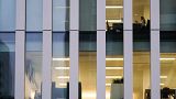 A worker sits in an office in the financial district in London