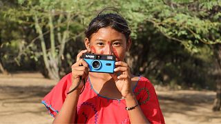 Manuela, 13, from the Indigenous Wayuu community, takes a photo.