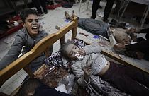 Palestinians wounded in the Israeli bombardment of the Gaza Strip arrive at a hospital in Khan Younis on Friday, Dec. 8, 2023. 