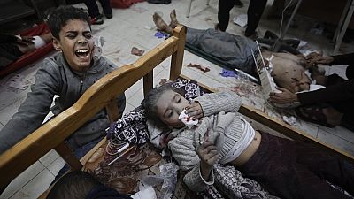 Palestinians wounded in the Israeli bombardment of the Gaza Strip arrive at a hospital in Khan Younis on Friday, Dec. 8, 2023. 