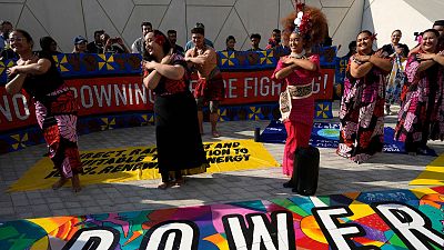 Activists hold a demonstration for climate solutions at the COP28 summit in Dubai, United Arab Emirates, 8 December.