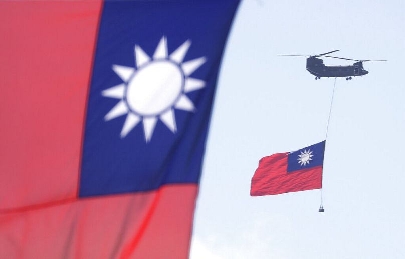 Helicopters fly over President Office with Taiwan National flag during National Day celebrations in front of the Presidential Building in Taipei, October 2021