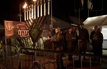  Israeli soldiers from the Givati Brigade mark the first night of the Jewish holiday of Hanukkah by lighting the first candle on their base in southern Israel