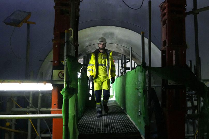 A worker walks at the construction site of a nuclear reactor at Hinkley Point C nuclear power station in Somerset, October 2022