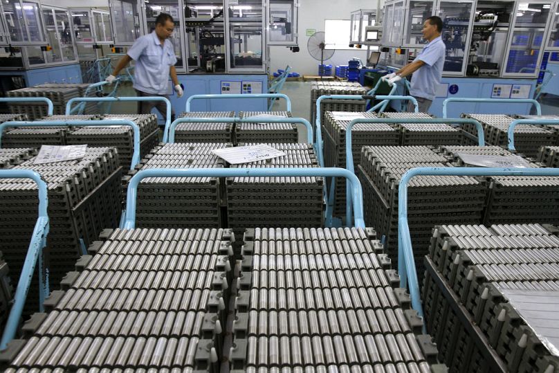 Workers transfer Lithium-ion batteries in a factory in Taizhou in east China's Jiangsu province, July 2018