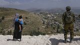 Israeli soldiers secure the construction site as Jewish settlers work at a seminary that was built overnight in the West Bank outpost of Homesh, Monday, May 29, 2023