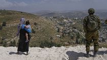 Israeli soldiers secure the construction site as Jewish settlers work at a seminary that was built overnight in the West Bank outpost of Homesh, Monday, May 29, 2023