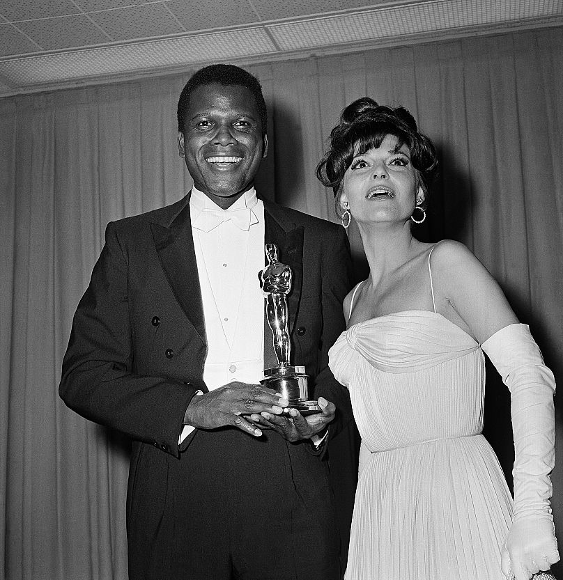 Sidney Poitier was named best actor of the year for 1964 for his role in "Lilies of the Field," awarded by actress Anne Bancroft, at right