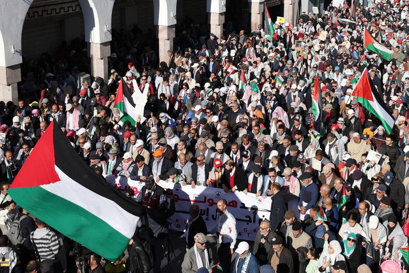 Moroccans wave Palestinian flags during a protest in Rabat on Sunday