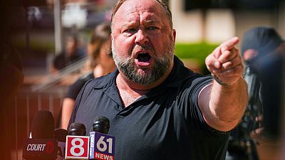 InfoWars founder Alex Jones speaks to the media outside Waterbury Superior Court during his trial in Waterbury, Connecticut last year