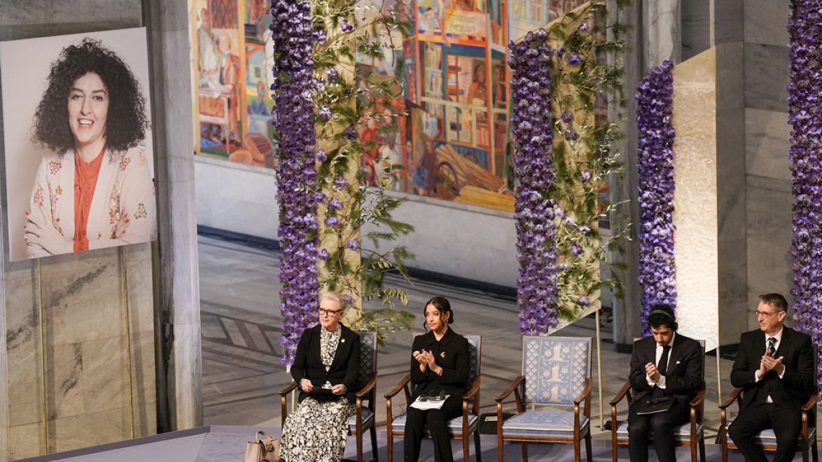 Ali, second right, and Kiana Rahmani, second left, attend the awarding of the Nobel Peace Prize for 2023 to their mother, imprisoned Iranian activist Narges Mohammadi.