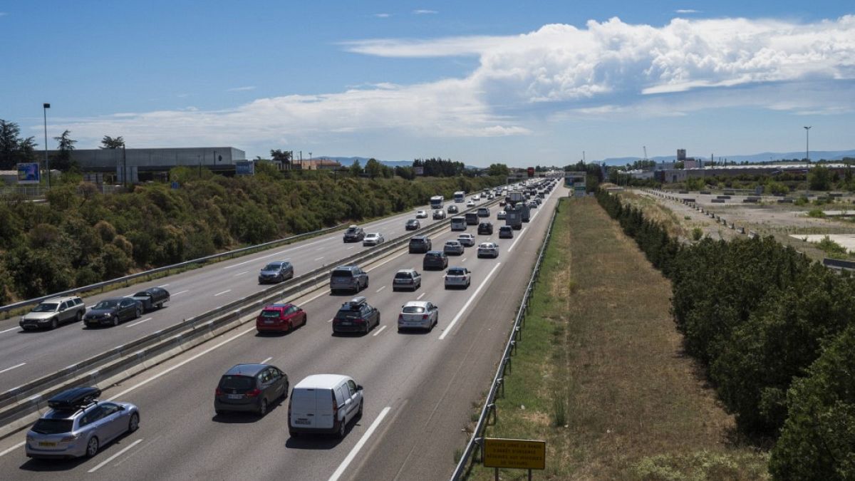 Motorists drive southbound (C) and northbound (L) on the A7 highway near Valence, southeastern France