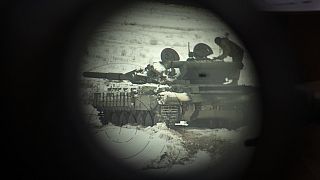 A Ukrainian tank is seen through binoculars during military training in Ukraine Wednesday, Dec. 6, 2023.