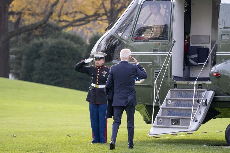 President Joe Biden salutes as he boards Marine One to depart the South Lawn of the White House, December 2023