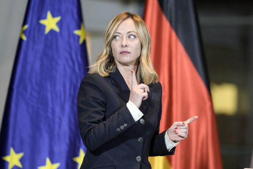 Italian Prime Minister Giorgia Meloni in front of a European and German flag during a meeting of German and Italian government at the chancellery in Berlin, November 2022