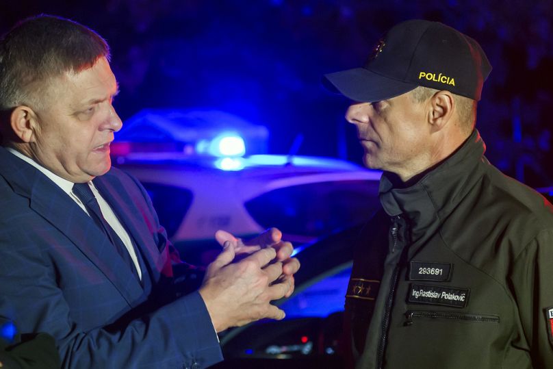 Slovakian Prime Minister Robert Fico, left, speaks with a police officer at the Cunovo-Rajka border crossing with Hungary, October 2023