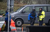 Police officers control cars near Saint Maurice, as they search for a gunman who killed two people and injured another in the southern Swiss town of Sion, on December 11, 2023