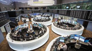 Stock traders work in the trading hall of the Frankfurt, Germany, stock exchange 