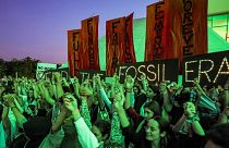 Climate activists attend a protest against fossil fuels during COP28. 