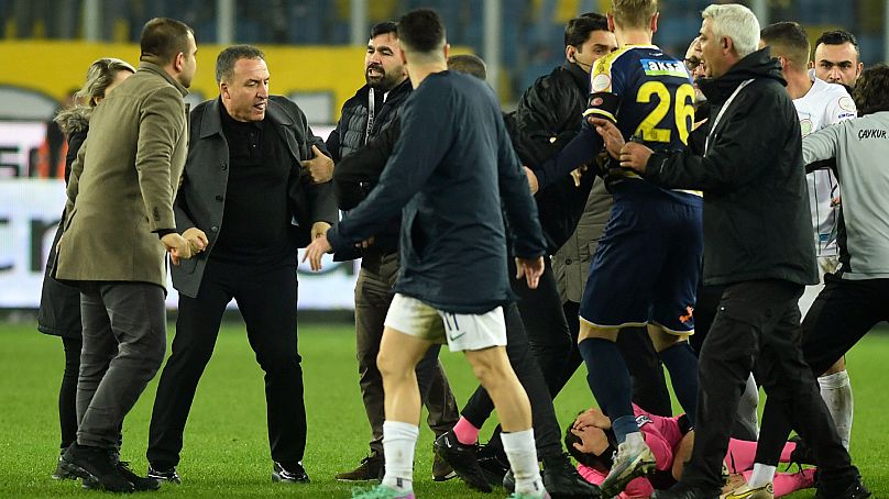 Referee Halil Umut Meler is seen lying on the ground after being punched by MKE Ankaragucu president Faruk Koca