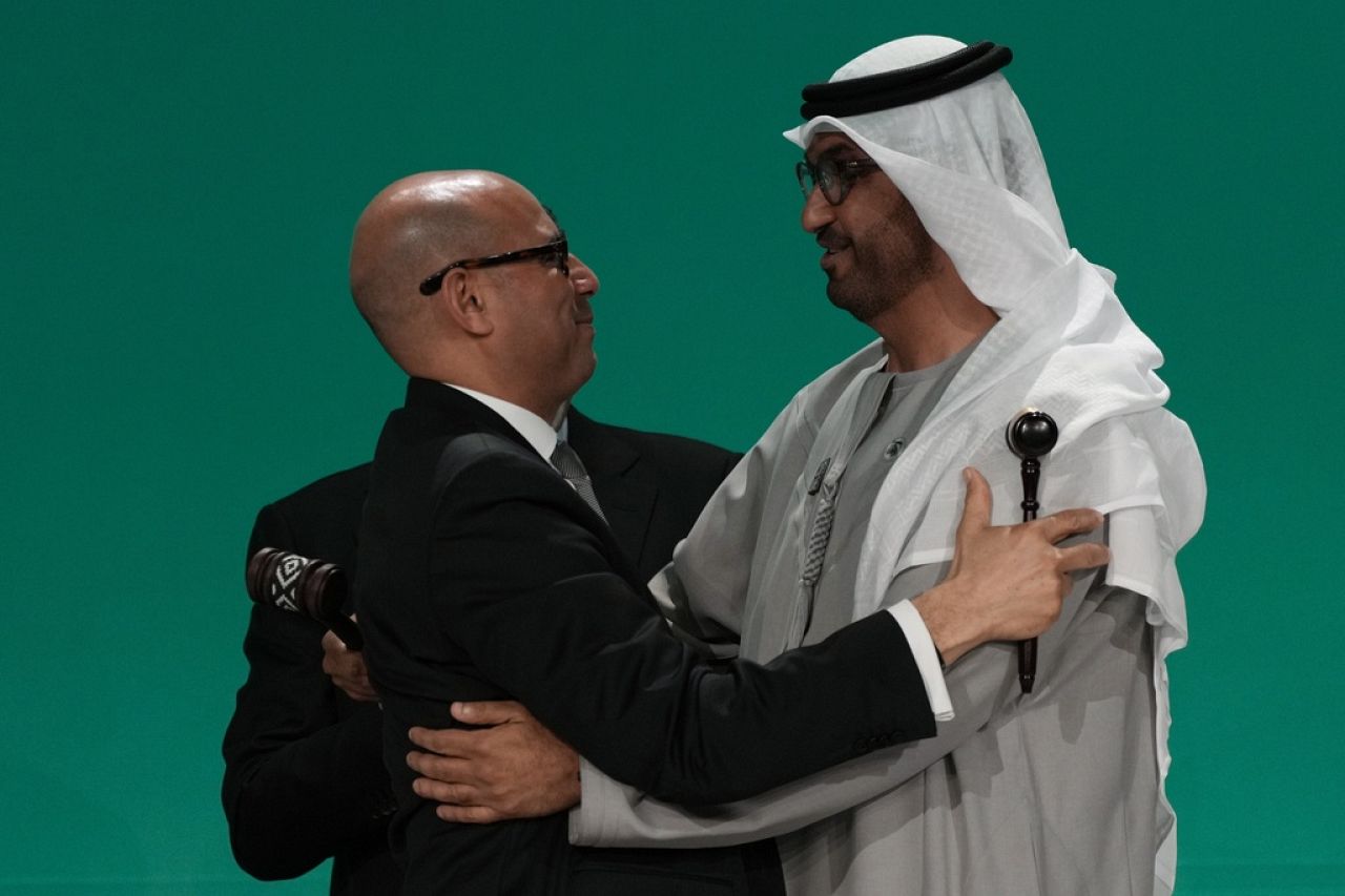 United Nations Climate Chief Simon Stiell embraces COP28 President Sultan al-Jaber, right, after the final gavel.