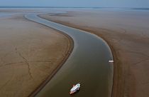 A ferry boat travels through a section of the Amazon River affected by a severe drought, near Manacapuru.