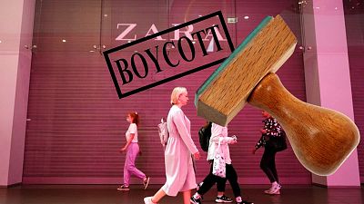 People walk past a Zara shop closed due to sanctions in a shopping mall in St. Petersburg, Russia, Tuesday, May 31, 2022. 