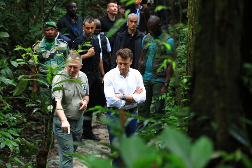 French President Emmanuel Macron with the Gabon Minister of Water and Forests, the Sea and the Environment Lee White in Libreville, March 2023