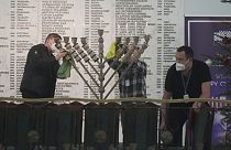 Workers in the Polish parliament clean up a menorah  Warsaw, Poland, on Tuesday Dec. 12, 2023. 