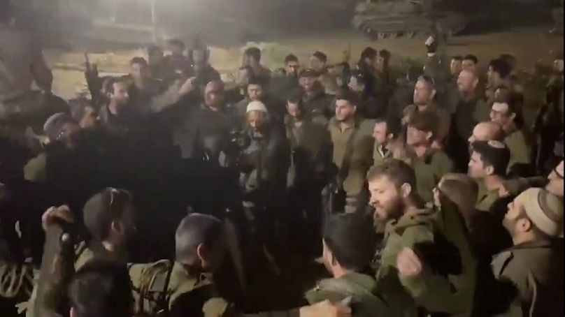 This image made from an undated video shared on X shows Israeli Army troops chanting racist slogans as they dance in a circle, in Gaza