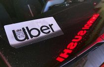 An Uber sign is displayed inside a car in Glenview, Ill., on Dec. 17, 2022. 