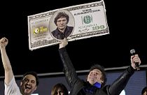 Javier Milei, Liberty Advances coalition presidential candidate, holds a cardboard image of a $100 dollar bill bedecked with an image of his face during his closing campaign.