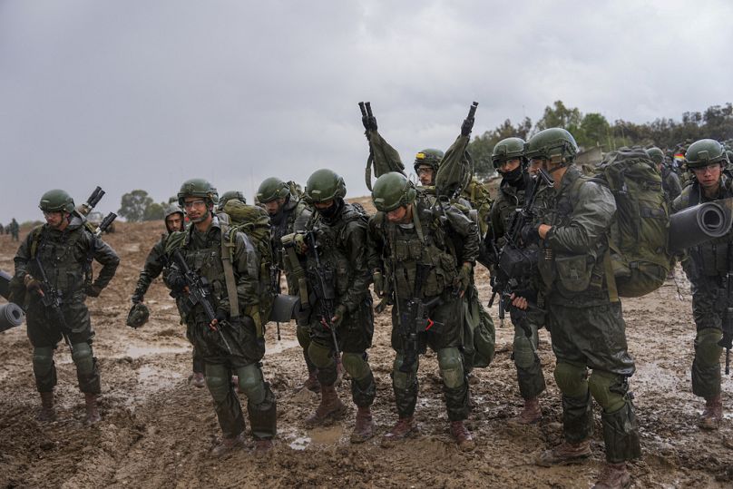 Israeli soldiers prepare to enter the Gaza Strip, at a staging area near the Israeli-Gaza border, in southern Israel, Wednesday, 13 De, 2023.