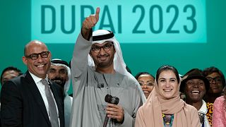 From left, UN Climate Chief Simon Stiell, COP28 President Sultan Al Jaber and Hana Al-Hashimi, chief COP28 negotiator for the United Arab Emirates, pose for photos at the end.
