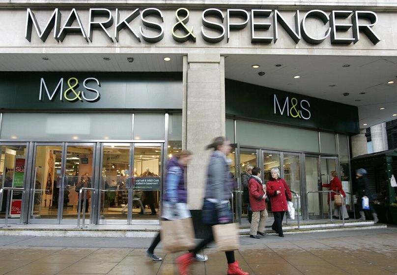 FILE: Shoppers walk past a Marks & Spencer store on Oxford Street in London, Tuesday, Jan. 11, 2011.