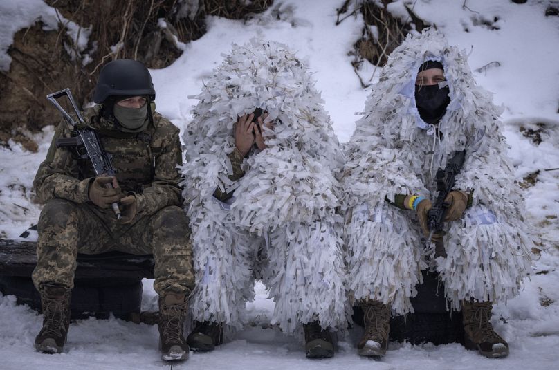 Members of the pro-Ukrainian Russian ethnic Siberian Battalion rest at a military training close to Kyiv.