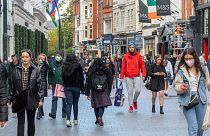 Shoppers walk through a busy Grafton Street in Dublin on October 21, 2020 