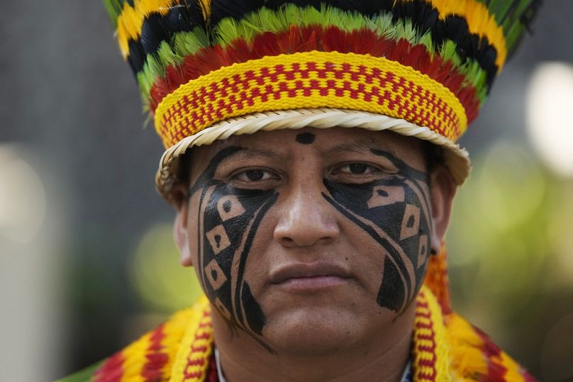 An Indigenous man, from Brazil, poses for a photo at the COP28 UN Climate Summit in Dubai, December 2023