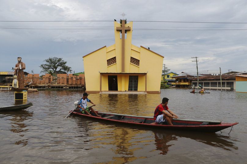 Residents navigate flooded streets in Anama, Amazonas state, Brazil, May 2021