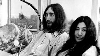 John Lennon and his wife, Yoko Ono, hold a bed-in for peace in room 902, the presidential suite at the Hilton Hotel in Amsterdam on March 25, 1969