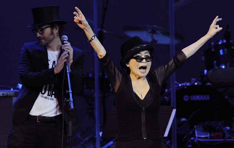 Yoko Ono, right, salutes the crowd alongside her son Sean Lennon at the close of the "Yoko Ono: We Are Plastic Ono Band" concert at the Orpheum Theater in 2010