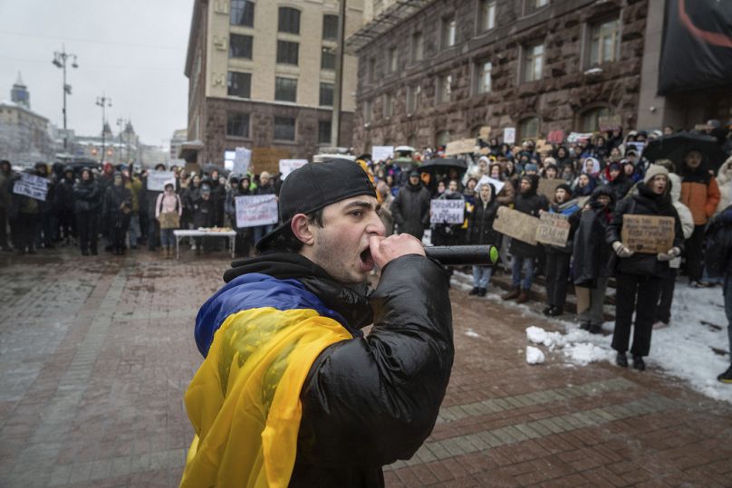 An activist shouts with a microphone during a protest in front of the city council of Kyiv