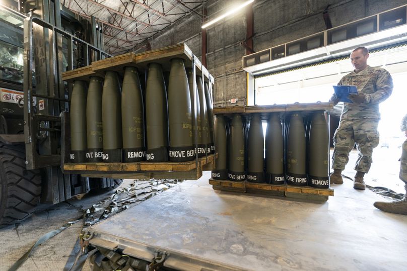 US Air Force Staff Sgt. Cody Brown with the 436th Aerial Port Squadron, checks pallets of 155 mm shells ultimately bound for Ukraine last year