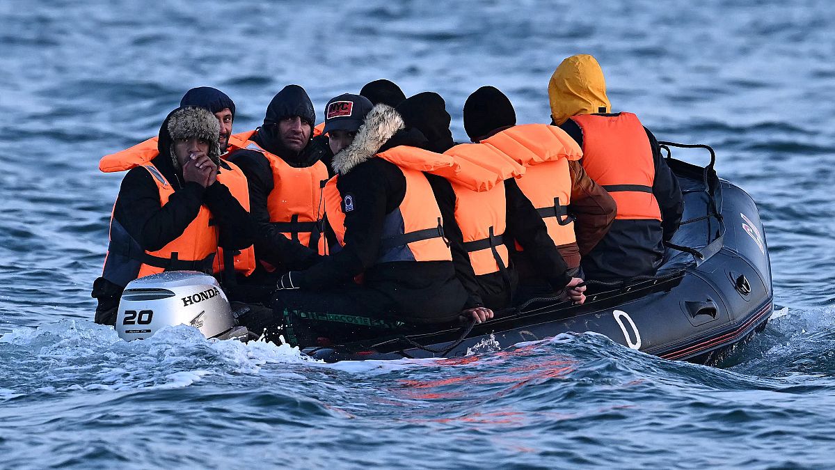Migrants travel in an inflatable boat across the English Channel, bound for Dover on the south coast of England. 
