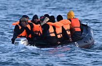 Migrants travel in an inflatable boat across the English Channel, bound for Dover on the south coast of England. 