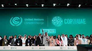 United Nations Climate Chief Simon Stiell, from left, COP28 President Sultan al-Jaber and Hana Al-Hashimi, chief COP28 negotiator for the UAE, pose for photos.