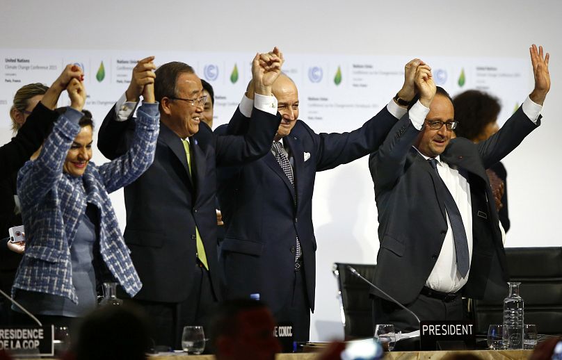 Celebration as the Paris Agreement is adopted at COP21 in Paris France in 2015.