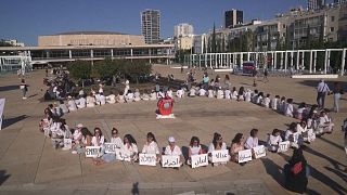 عشرات النساء يتجمعن في تل أبيب للاحتجاج على الحرب بين إسرائيل وحماس.