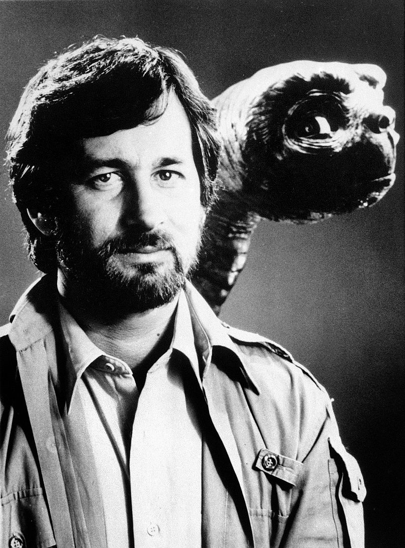 Steven Spielberg poses with alien character E.T. in London, Dec. 1982