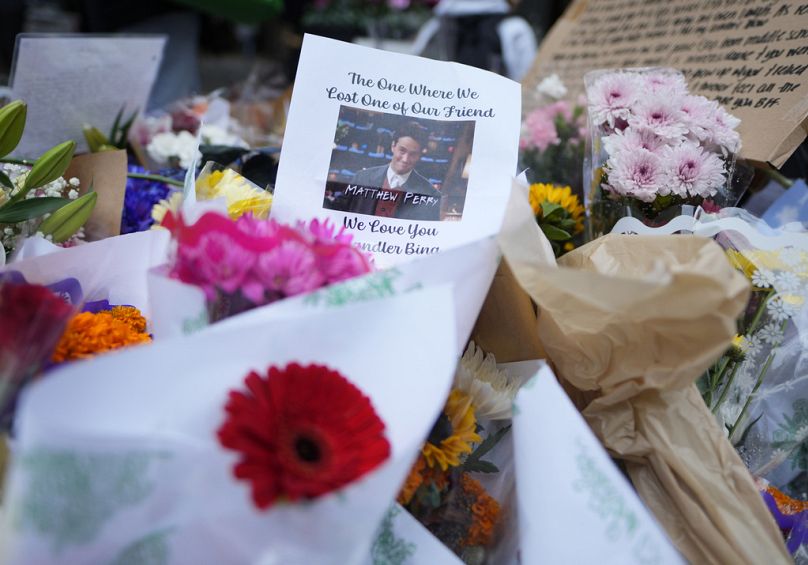 A makeshift memorial for Matthew Perry is seen outside the building shown in exterior shots of the television show "Friends"